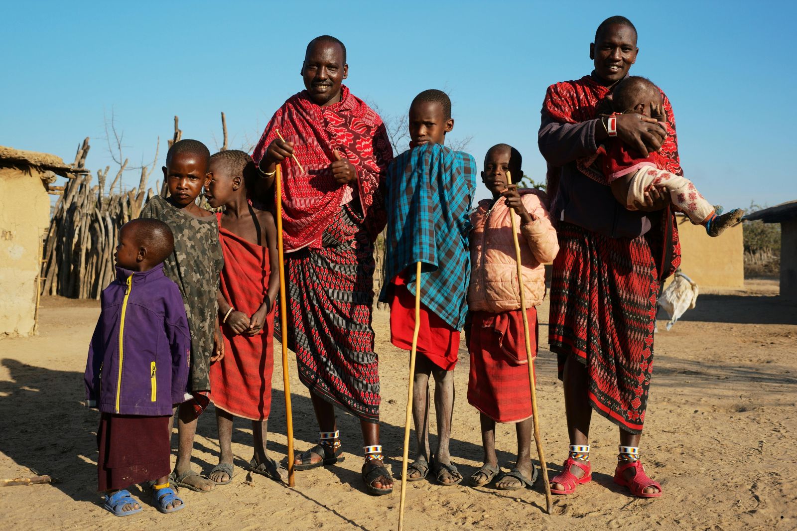 Maasai family outside a traditional village