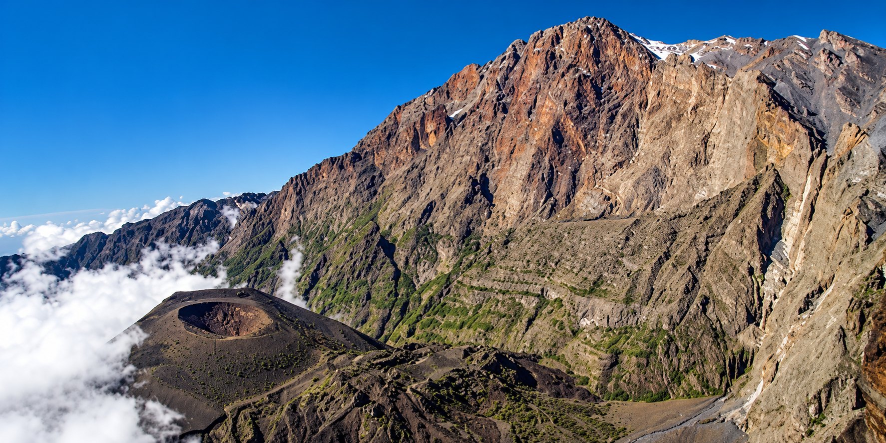 Mount Meru crater and rugged volcanic ridges above the clouds